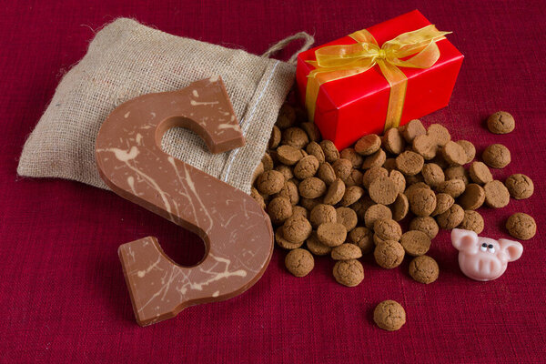 Dutch Sinterklaas tradition: A chocolate letter, a present and a bag with candy called Pepernoten.
