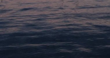 Waves on the shore at dawn, macro photography, natural background.