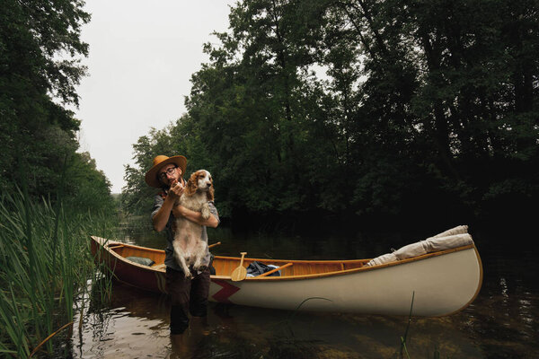 Young Man Stands Shallow River Next His Canoe Dog Adventurous Royalty Free Stock Photos