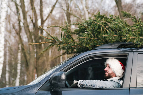 Man Wearing Santa Claus Hat Car Christmas Tree Roof New Royalty Free Stock Photos