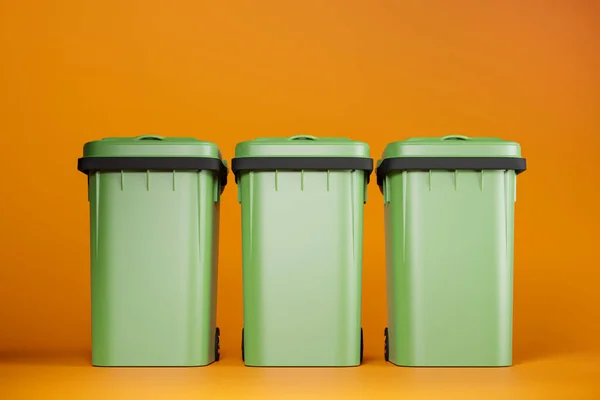 Green garbage bins on orange background, 3d render illustration. Sorting trash or litter, recycling concept, clean and neat copy space background, vivid colors