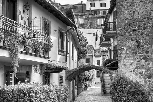 Suggestive black and white street view at ancient medieval village of Anguillara Sabazia in Rome provincia, Italy