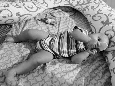 Renkli fotoğraf için poz veren çocuk yüzlü güzel erkek bebek, çocuk imajı olan erkek bebek kadrosu, beyaz yüz ifadesi, çocuk suratlı sağlıklı bir erkek çocuğu, iyi bir çekim için dinleniyor.