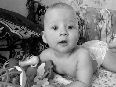 Renkli fotoğraf için poz veren çocuk yüzlü güzel erkek bebek, çocuk imajı olan erkek bebek kadrosu, beyaz yüz ifadesi, çocuk suratlı sağlıklı bir erkek çocuğu, iyi bir çekim için dinleniyor.