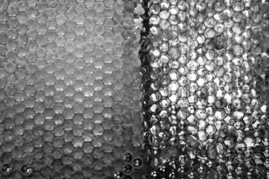 Altın nektarla dolu altıgen bal peteklerinden arı damlayan bal damlası, bal peteği yaz kompozisyonu doğal bal damlası, balmumu çerçeve arısına damlayan bal damlası, bal peteğine damlayan bal damlası