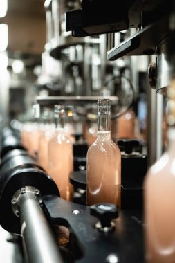 Industrial wine bottling plant theme. Modern industry production line for alcohol drink bottling and packaging. 