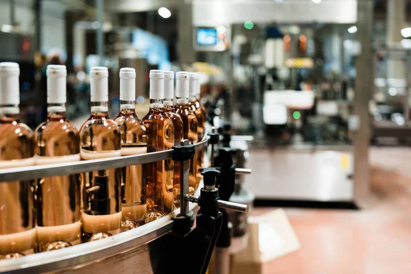 Industrial wine bottling plant theme. Modern industry production line for alcohol drink bottling and packaging.