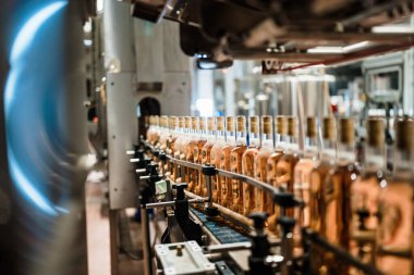 Industrial wine bottling plant theme. Modern industry production line for alcohol drink bottling and packaging. 