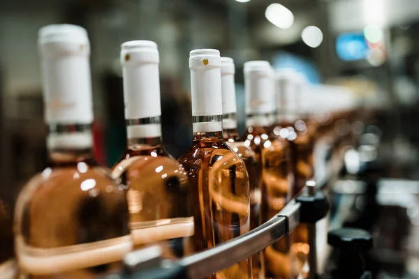 Industrial wine bottling plant theme. Modern industry production line for alcohol drink bottling and packaging.