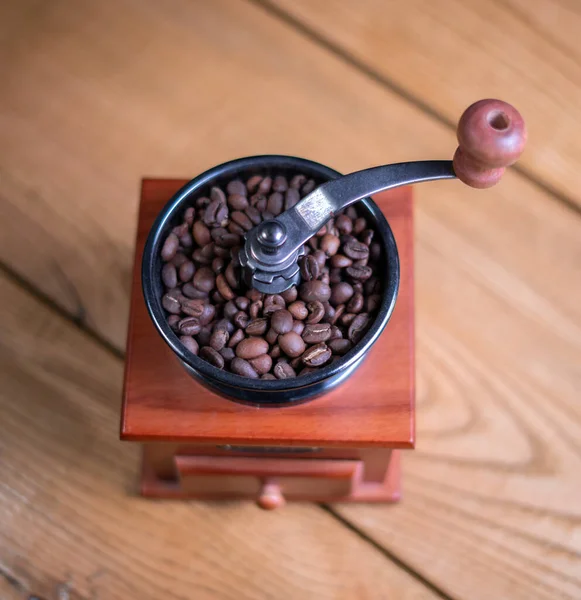 Old vintage grinder with roasted coffee beans and grind coffee
