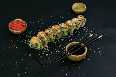 Hot fried Sushi Roll with shrimps, avocado, lettuce and cheese. Sushi menu. Japanese food
