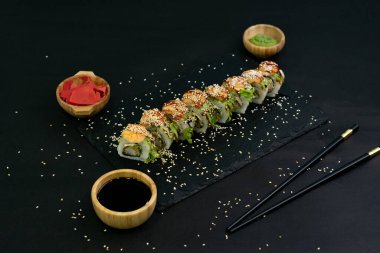 Hot fried Sushi Roll with shrimps, avocado, lettuce and cheese. Sushi menu. Japanese food