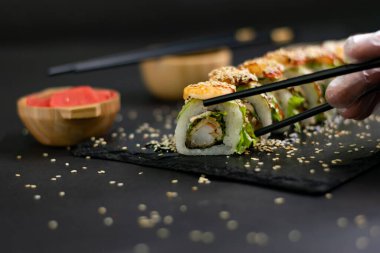 Hot fried Sushi Roll with shrimps, avocado, lettuce and cheese. Sushi menu. Japanese food