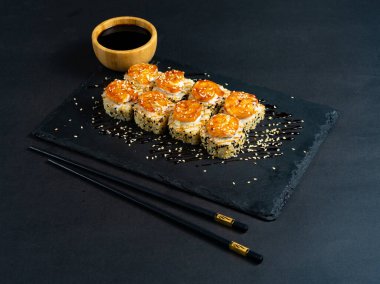 Shrimp sushi with sesame on black plate. Japanese sushi