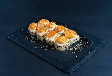 Shrimp sushi with sesame on black plate. Japanese sushi