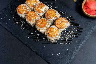 Shrimp sushi with sesame on black plate. Japanese sushi