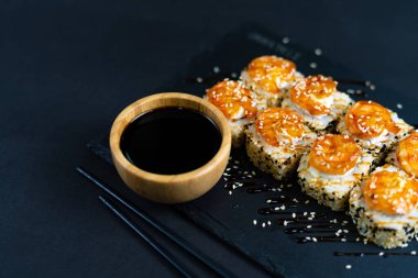 Shrimp sushi with sesame on black plate. Japanese sushi
