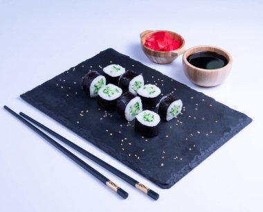 Sushi Maki rolls cucumber. Fresh hosomaki pieces with rice and nori. Close Up of delicious japanese food with sushi roll.
