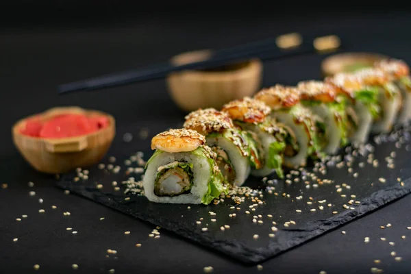 Hot fried Sushi Roll with shrimps, avocado, lettuce and cheese. Sushi menu. Japanese food