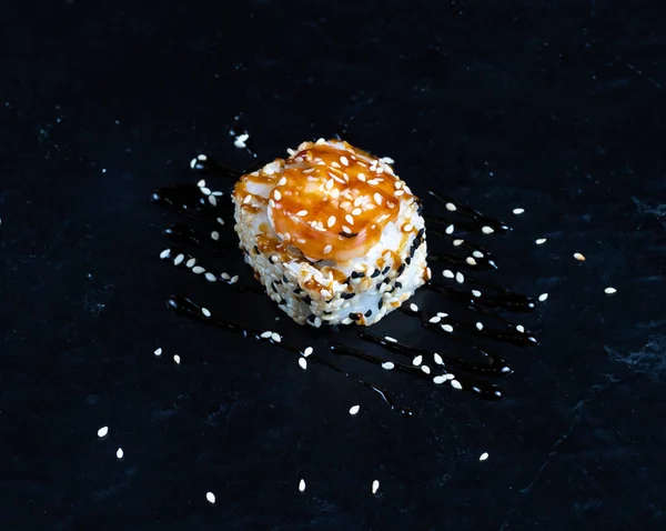 Shrimp sushi with sesame on black plate. Japanese sushi