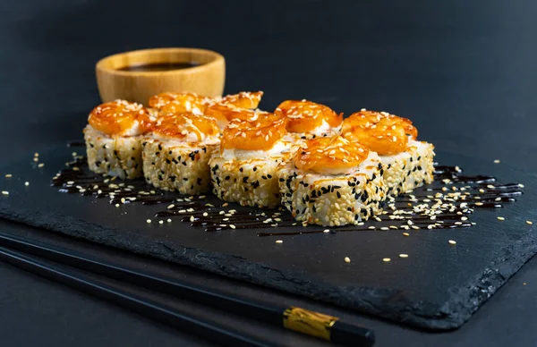 Shrimp sushi with sesame on black plate. Japanese sushi