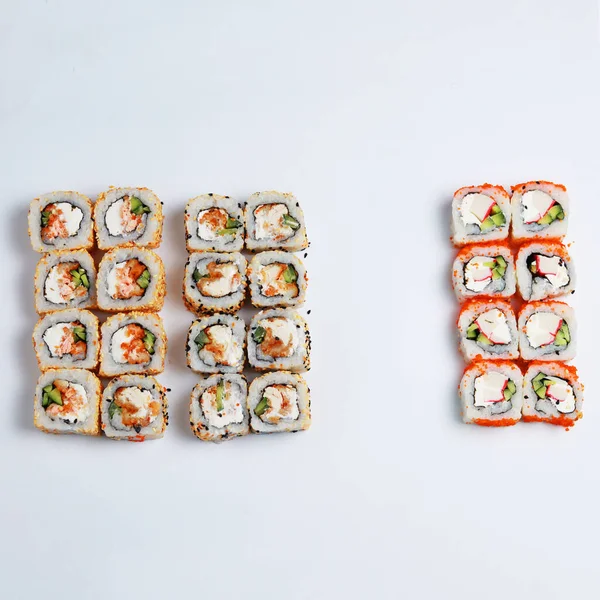 Assorted sushi set on white background.
