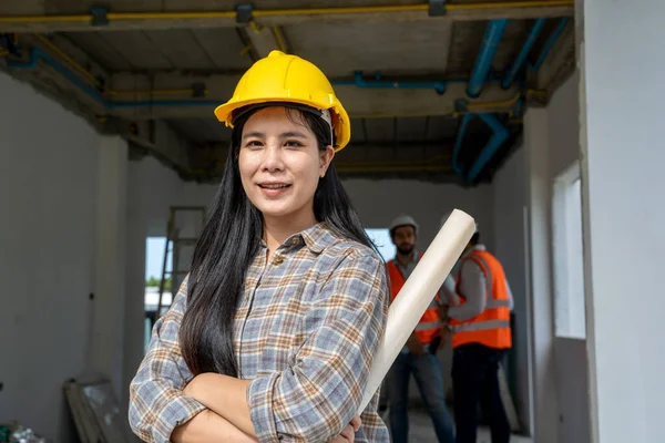 Architect women with building plan at construction site,business,building,industry,Real estate and development concept.