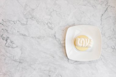 White cake on a light marble table. Background for cards for Valentine's Day