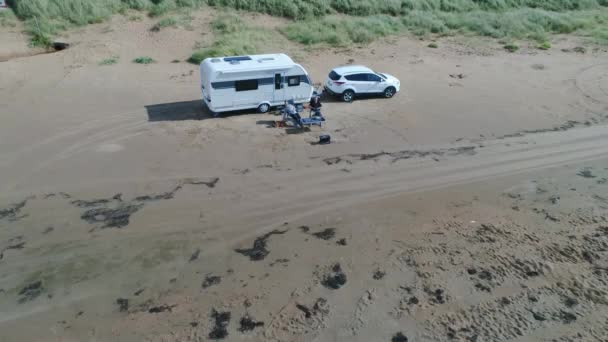 50fps aerial Couple with dog on Outdoor vacation caravan campsite camper in Melby beach, Sweden by the ocean — Stok Video