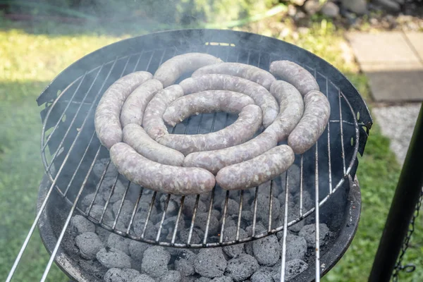 Barbecue grill bbq on coal charcoal grill with raw bratwurst sausages meat delicious summer meal — Stock Photo, Image