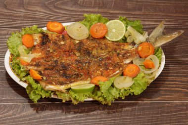 Roasted and open anchovy fish with vegetables