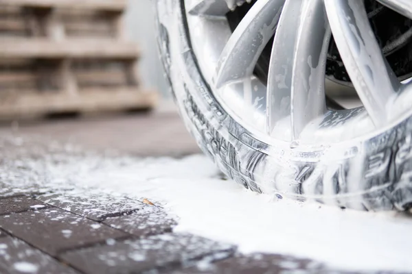 Yüksek Basınçlı Su ile Araba Temizleme. Elle oto yıkama dışarıda. Kapatın. Elle yıkama, beyaz sabunla, gövdede köpük. Sabunla yıka..