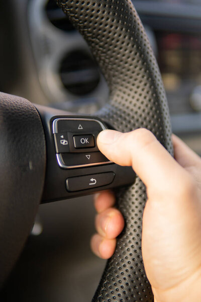 Driving car in traffic jam at urban city. Hand women holding steering wheel driving in traffic rush hour after finish work.