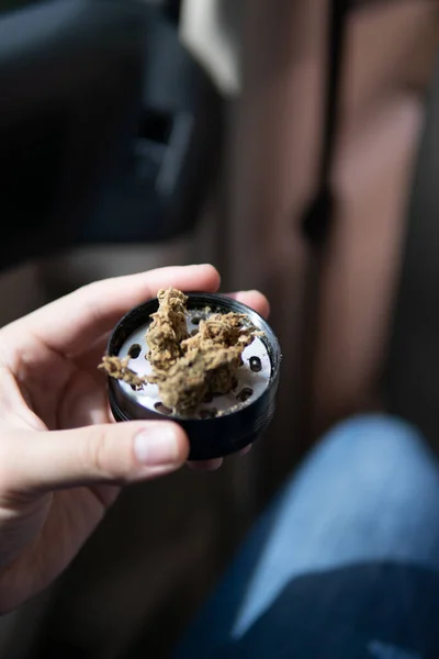 Weed on a car background close up marijuana bud flowers of cannabis. grinder —  Fotos de Stock