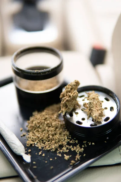 Cannabis. grinder and shredded cannabis joint and a packet of weed — Fotografie, imagine de stoc
