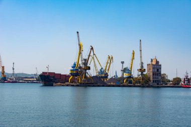 Burgas, Bulgaria - 17.05.2022: Sea port in Burgas, Bulgaria. Photo of the pier and port cranes on a summer day.