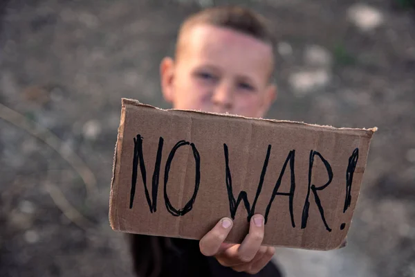 Boy Grimy Face Sad Eyes Holds Cardboard Poster Inscription War — Stock Photo, Image