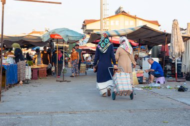 Antalya, Turkey 08.13.2022: Bazaar in the Turkish city near Alanya, people buy groceries, vegetables, fruits. Many people at the market choose and buy food on a sunny summer day. Turks in the market.