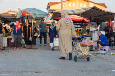 Antalya, Turkey 08.13.2022: Bazaar in the Turkish city near Alanya, people buy groceries, vegetables, fruits. Many people at the market choose and buy food on a sunny summer day. Turks in the market.