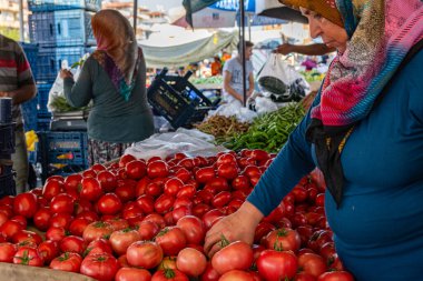 Antalya, Turkey 08.13.2022: Bazaar in the Turkish city near Alanya, people buy groceries, vegetables, fruits. Many people at the market choose and buy food on a sunny summer day. Turks in the market.
