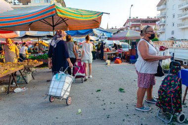 Antalya, Turkey 08.13.2022: Bazaar in the Turkish city near Alanya, people buy groceries, vegetables, fruits. Many people at the market choose and buy food on a sunny summer day. Turks in the market.