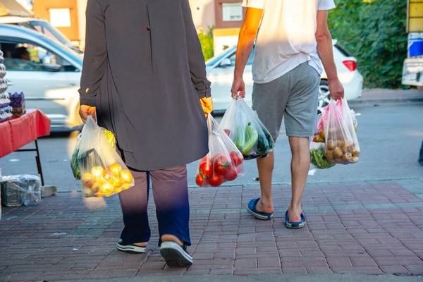 Antalya, Turkey 08.13.2022: Bazaar in the Turkish city near Alanya, people buy groceries, vegetables, fruits. Many people at the market choose and buy food on a sunny summer day. Turks in the market.