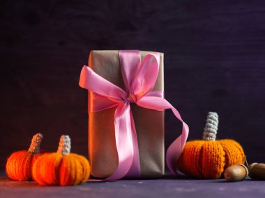 Hediye kutusu ve portakal rengi balkabakları. Cadılar Bayramı ya da Şükran Günü için bir sürpriz. Terfi ve satış kavramı