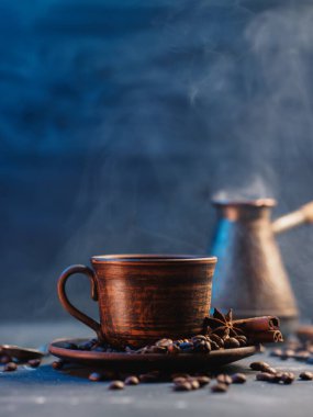 A cup of freshly brewed hot Turkish coffee, Roasted coffee beans, lots of steam, copy space