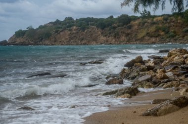 Deniz dalgaları, kum ve mavi gökyüzü