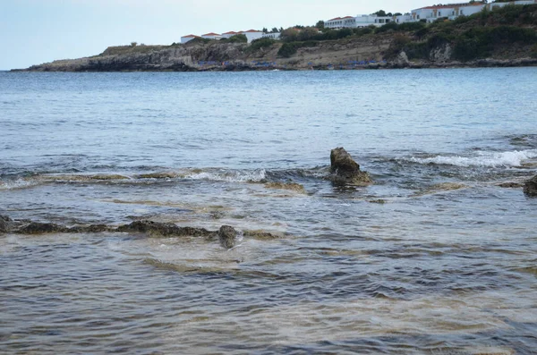 Deniz dalgaları, kum ve mavi gökyüzü