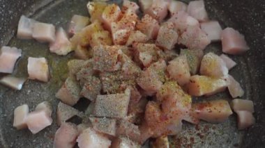 Biber, tuz, karabiber ve kuru kekik ile kaplanmış tavuklu fileto küp küp şeklinde kesilmiş.,