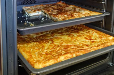 Fırında Türk usulü su hamur işi, bir tepsi dolusu hamur işi.,