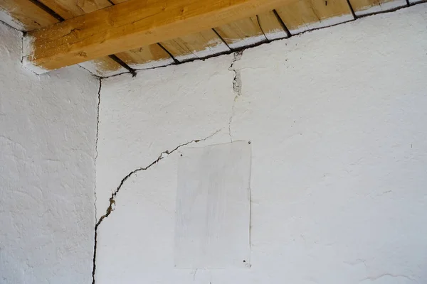 Damaged house with cracked walls, the house that was damaged after the earthquake,