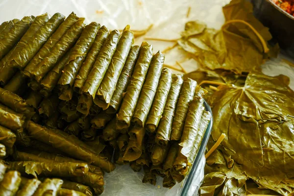 a cook making stuffed leaves, making stuffed leaves at home, stuffed leaves from Turkish cuisine,